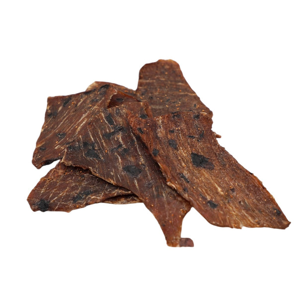 Three pieces of dried beef jerky on a white background