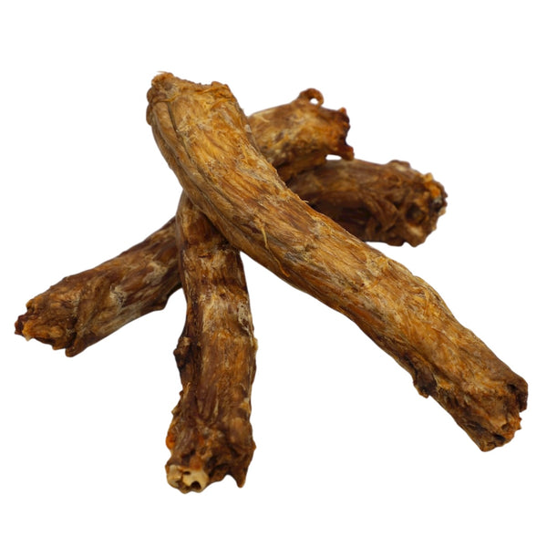 Three pieces of dried root or bark on a white background