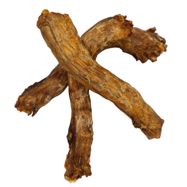Three pieces of dried ginseng root on a white background