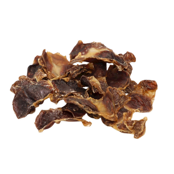 Dried beef jerky pieces on a white background