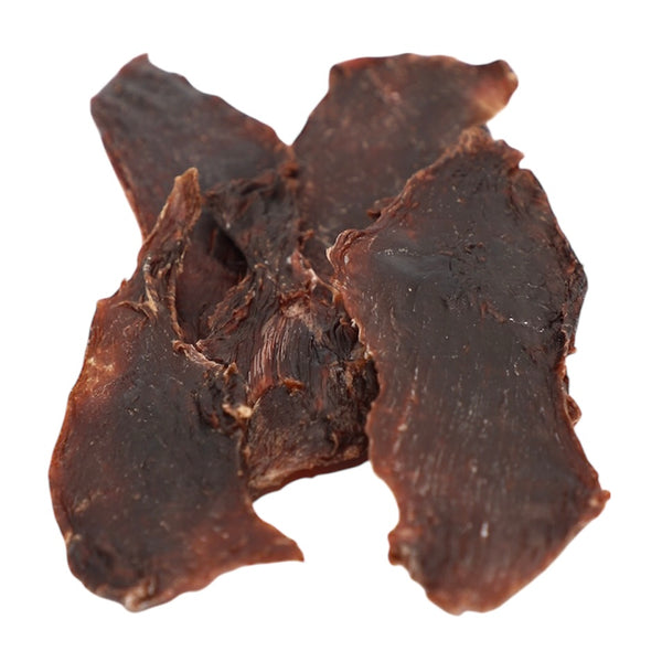 Close-up of a dark brown, textured object on a white background