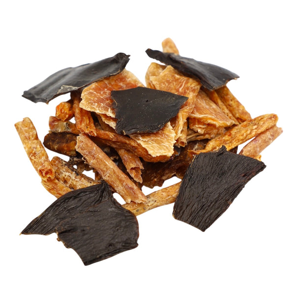 Dried fish and blackened fish pieces on a white background