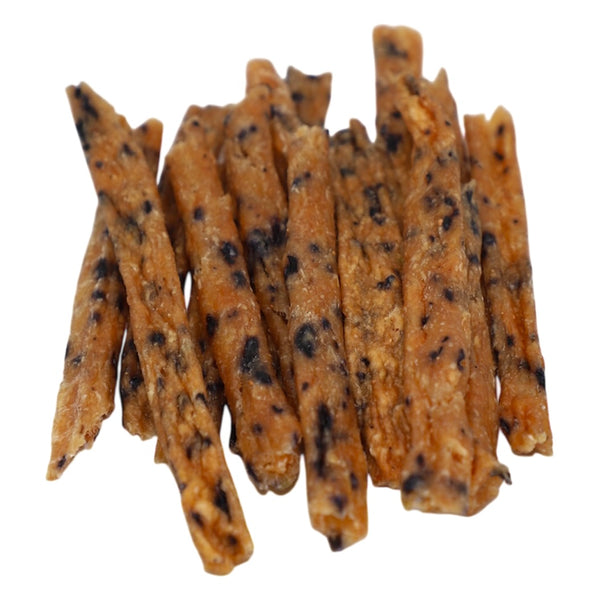 Dog treats with black specks on a white background