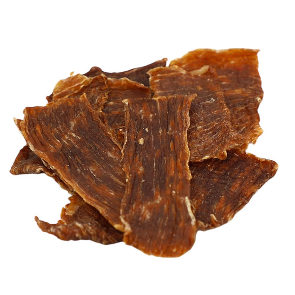Dried beef jerky pieces on a white background